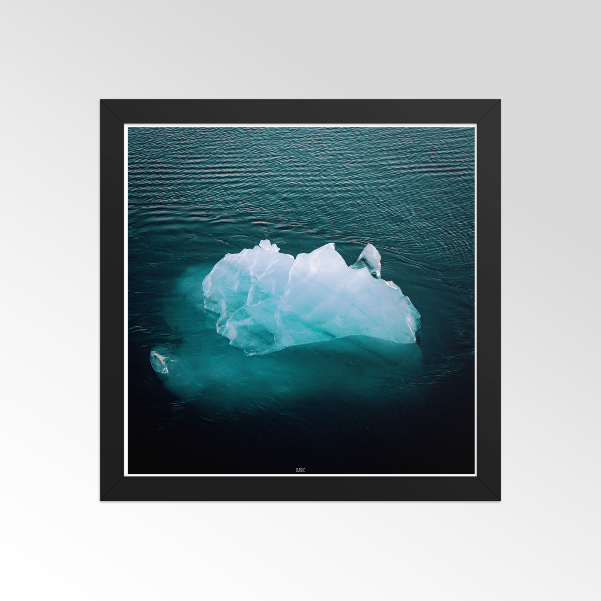 Iceberg floating in dark blue ocean framed print