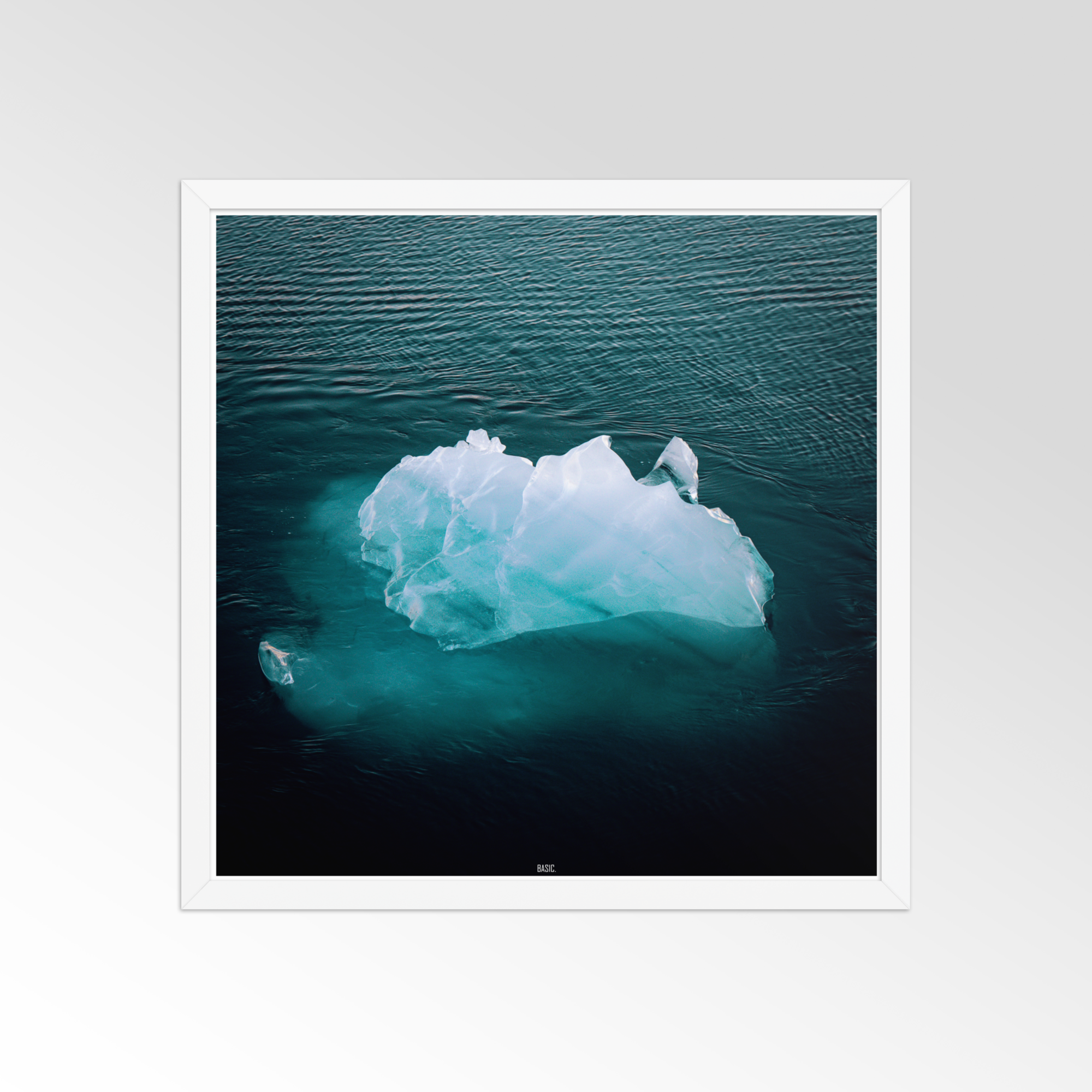 Framed photograph of an iceberg floating in water with a white border.