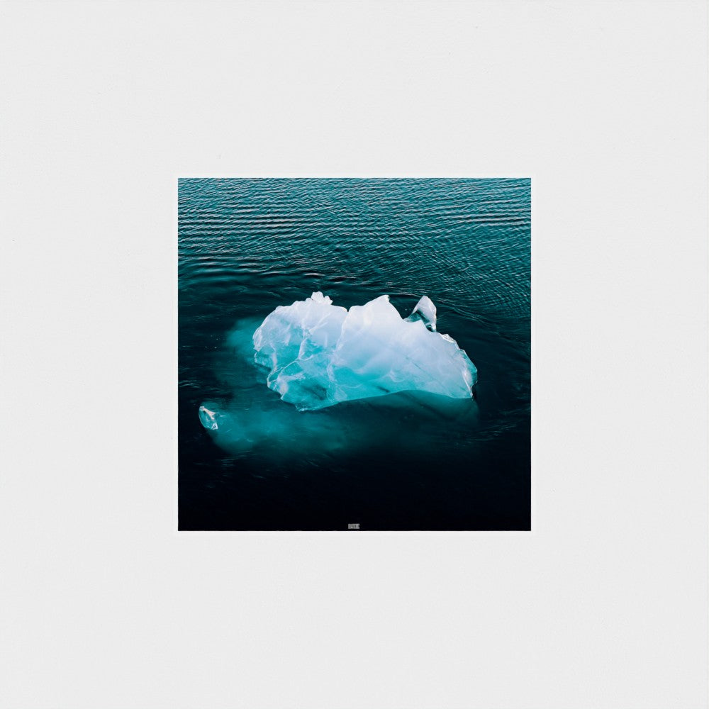 Iceberg floating in the ocean with a white border