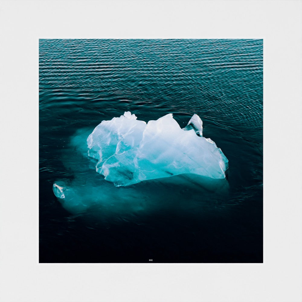 Iceberg floating in the ocean with a white border