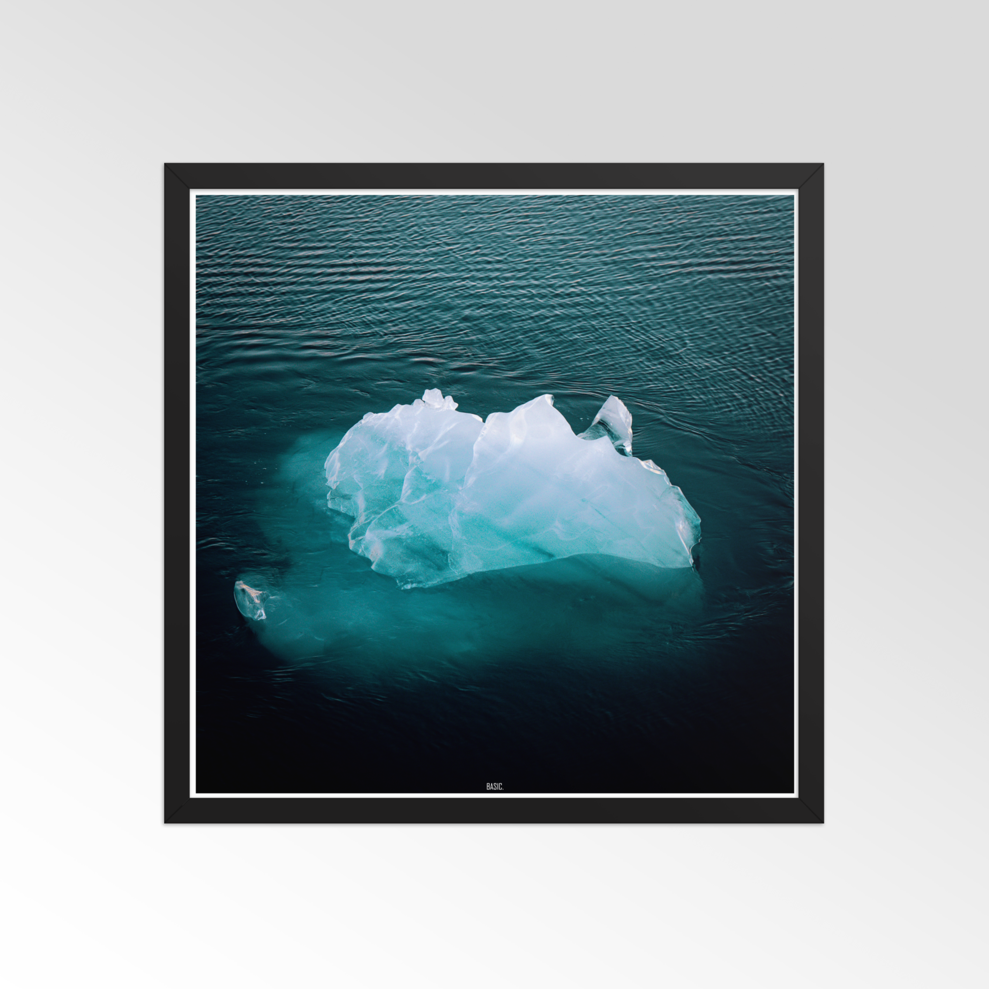 Framed photograph of an iceberg floating in water on a white background