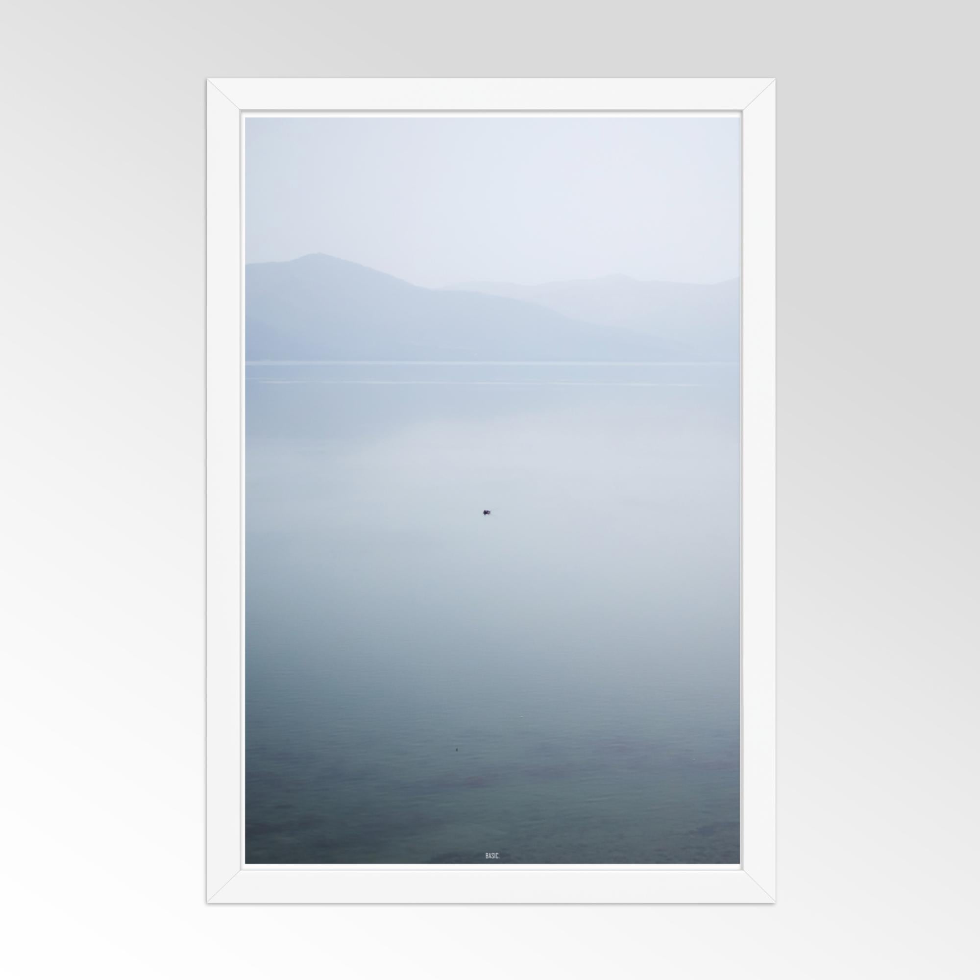 Framed artwork of a mountain landscape with a white frame on a gray background