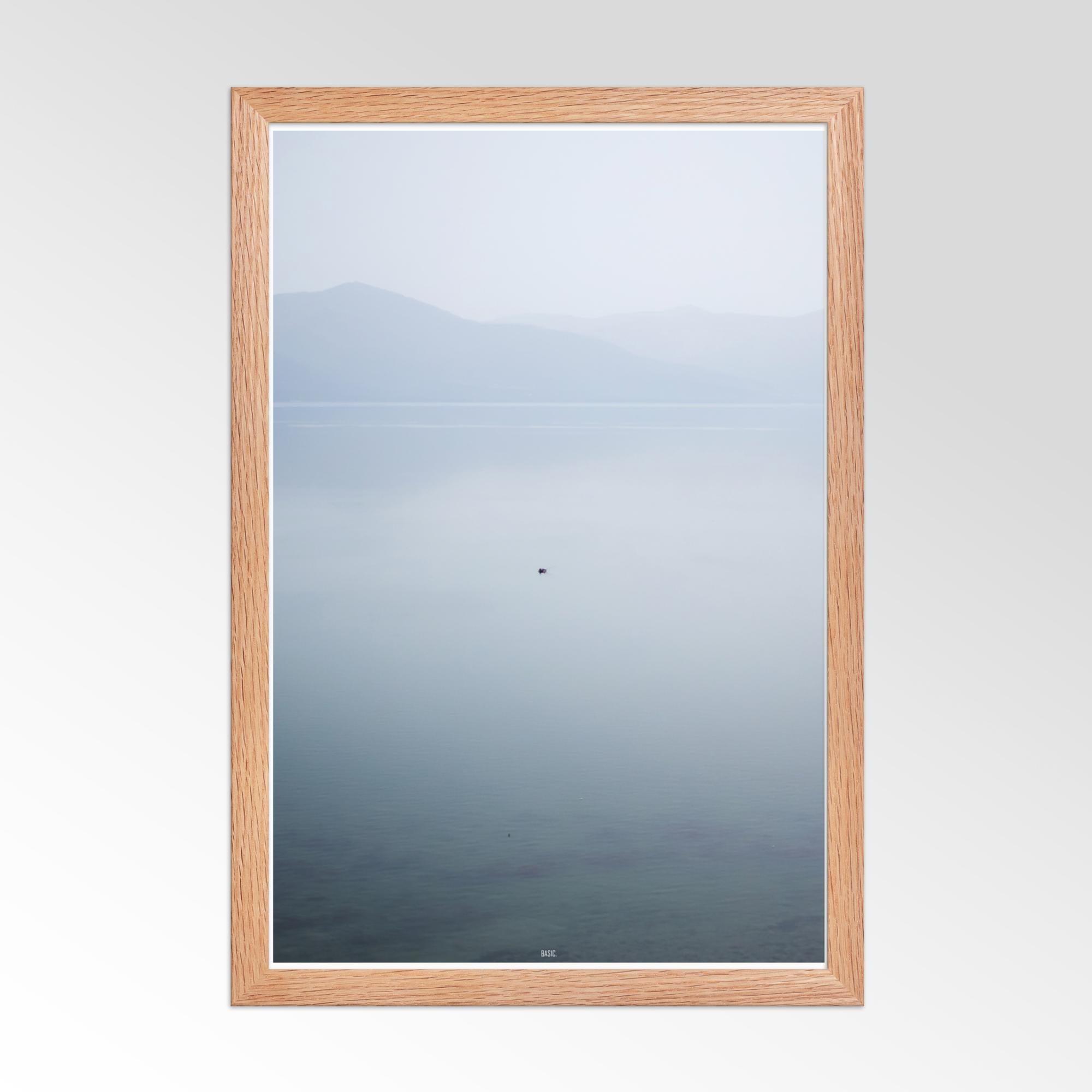 Mirror with wooden frame reflecting a mountainous landscape