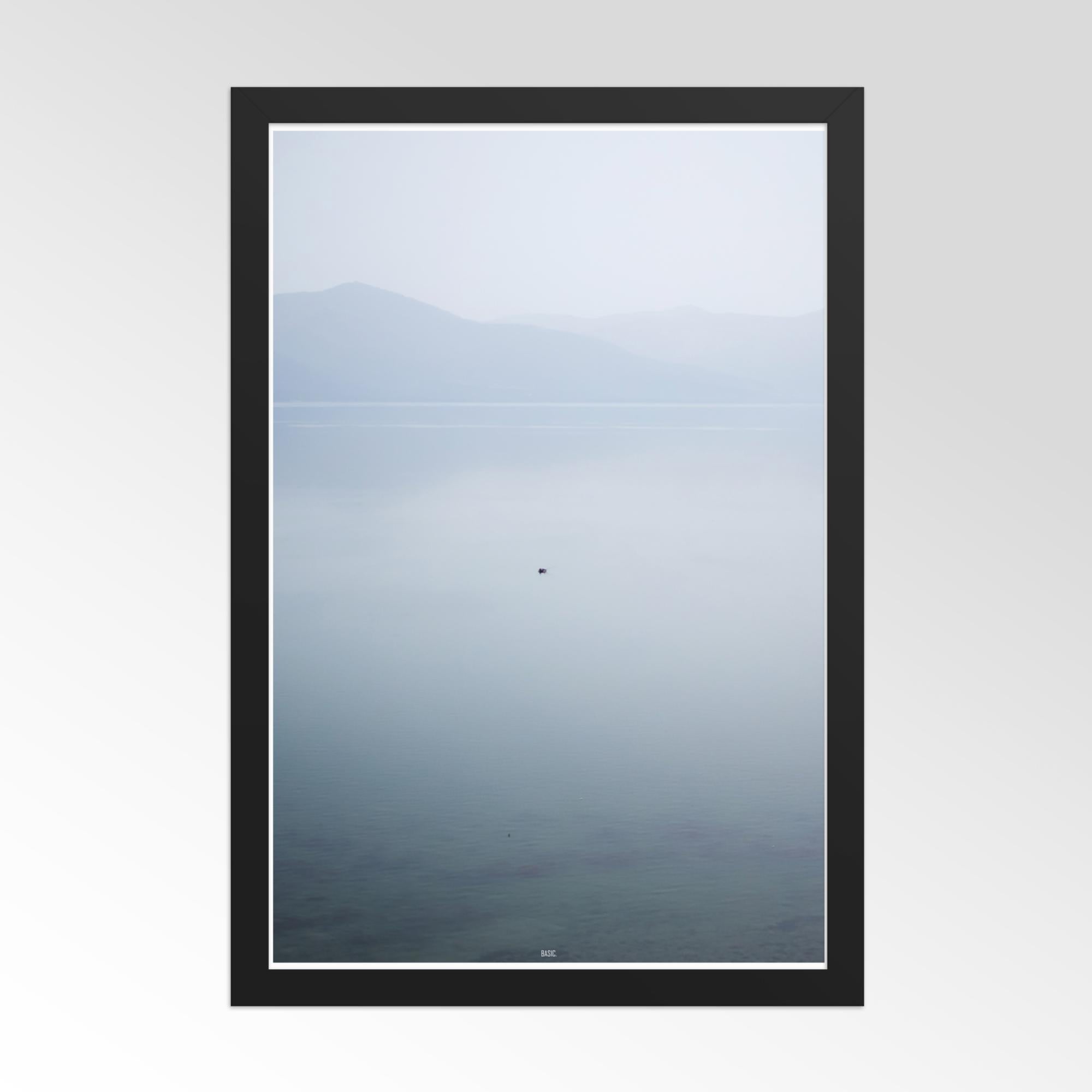 Framed artwork of a mountain landscape with a black border on a white background