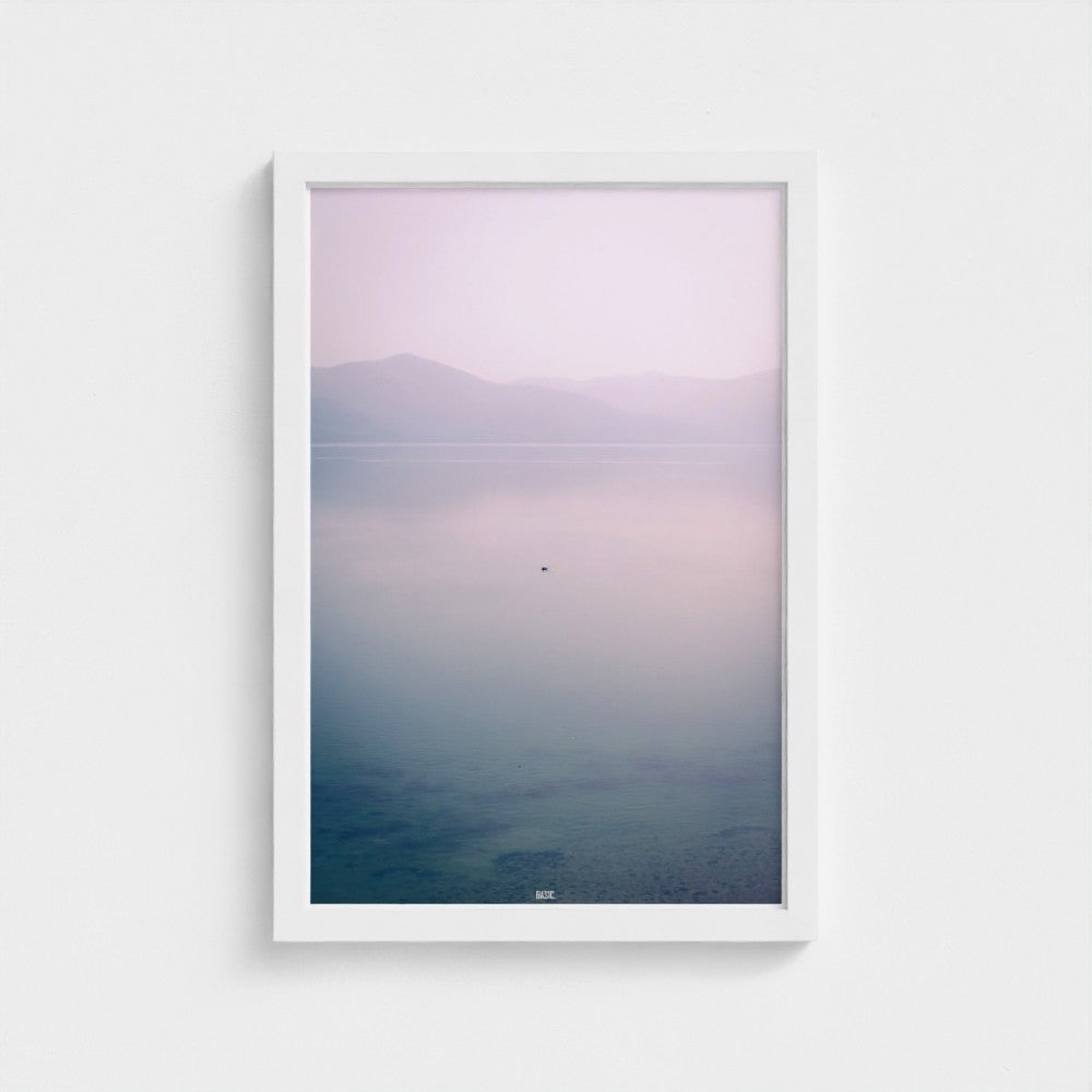 Framed artwork of a landscape with mountains and water, gradient from purple to blue.