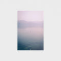 Unframed artwork with a gradient landscape from purple to blue on a white wall