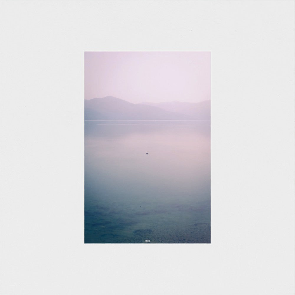 Unframed artwork with a gradient landscape from purple to blue on a white wall