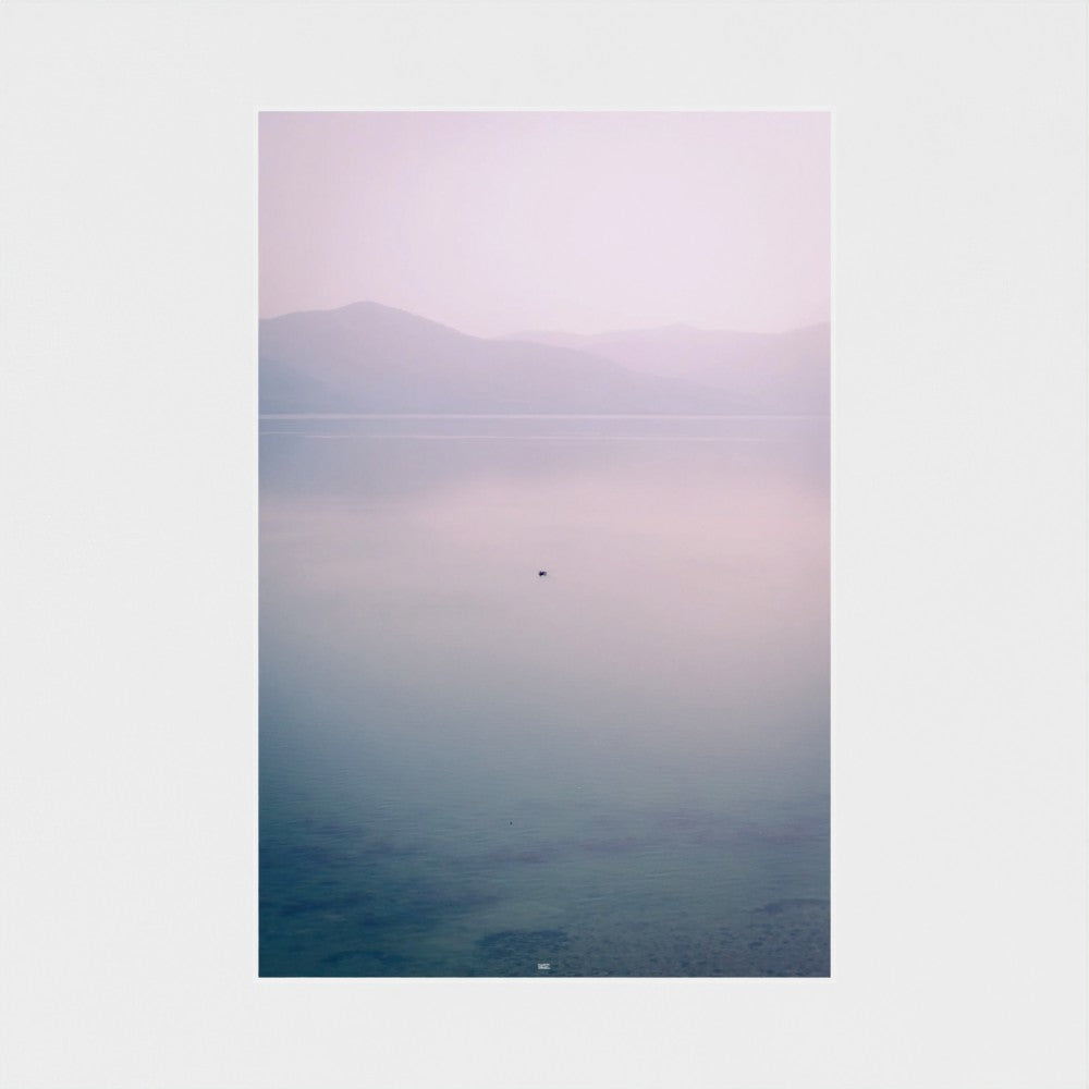 Unframed artwork with a gradient landscape from purple to blue on a white wall