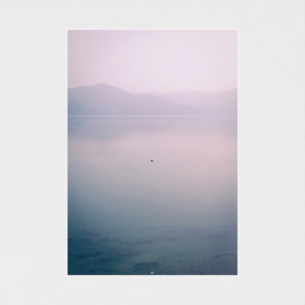 Unframed artwork with a gradient landscape from purple to blue on a white wall