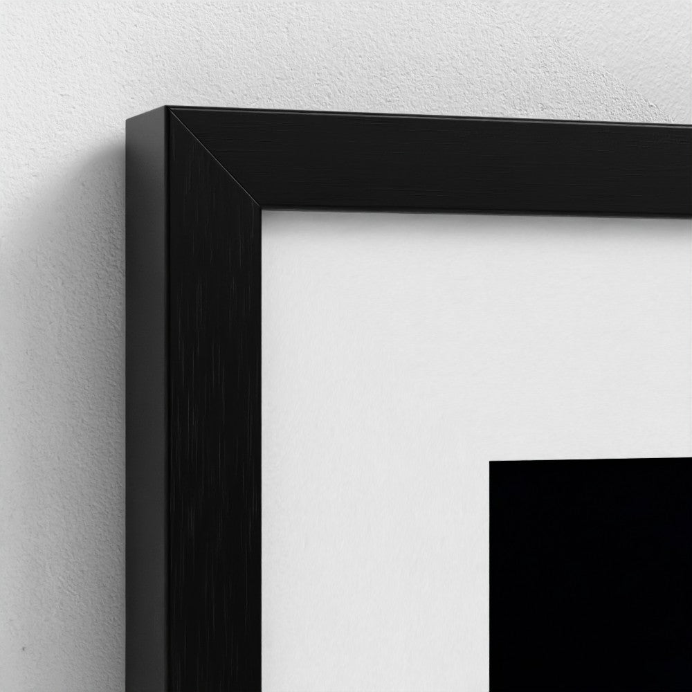 Close-up of a black picture frame on a white wall