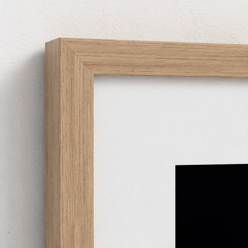 Close-up of a wooden picture frame on a white wall
