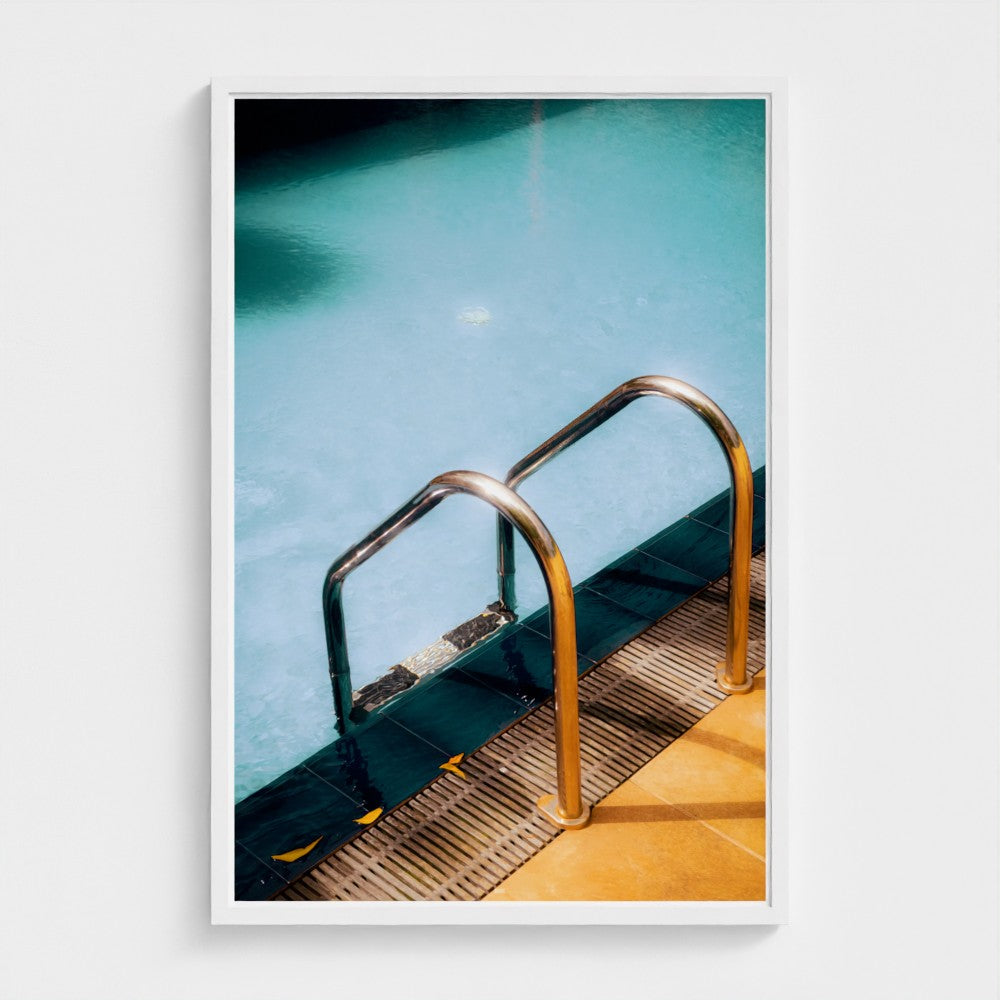 Framed photograph of a pool ladder with clear water