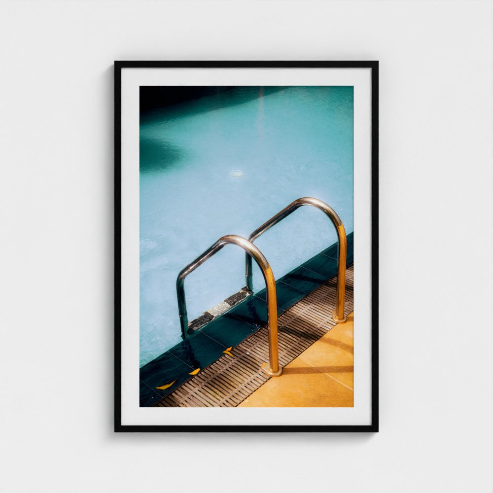 Framed photograph of a pool ladder with clear water