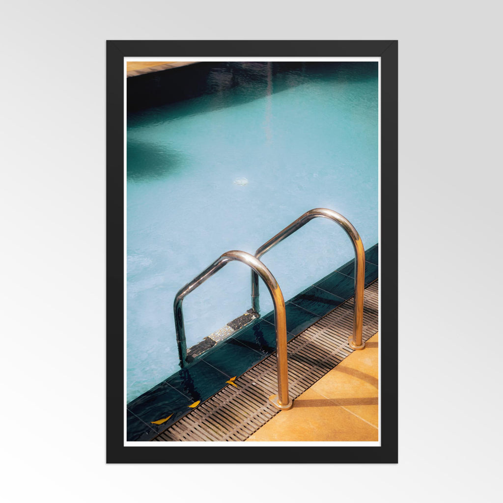 Framed photograph of a pool with a metal ladder on a light gray background