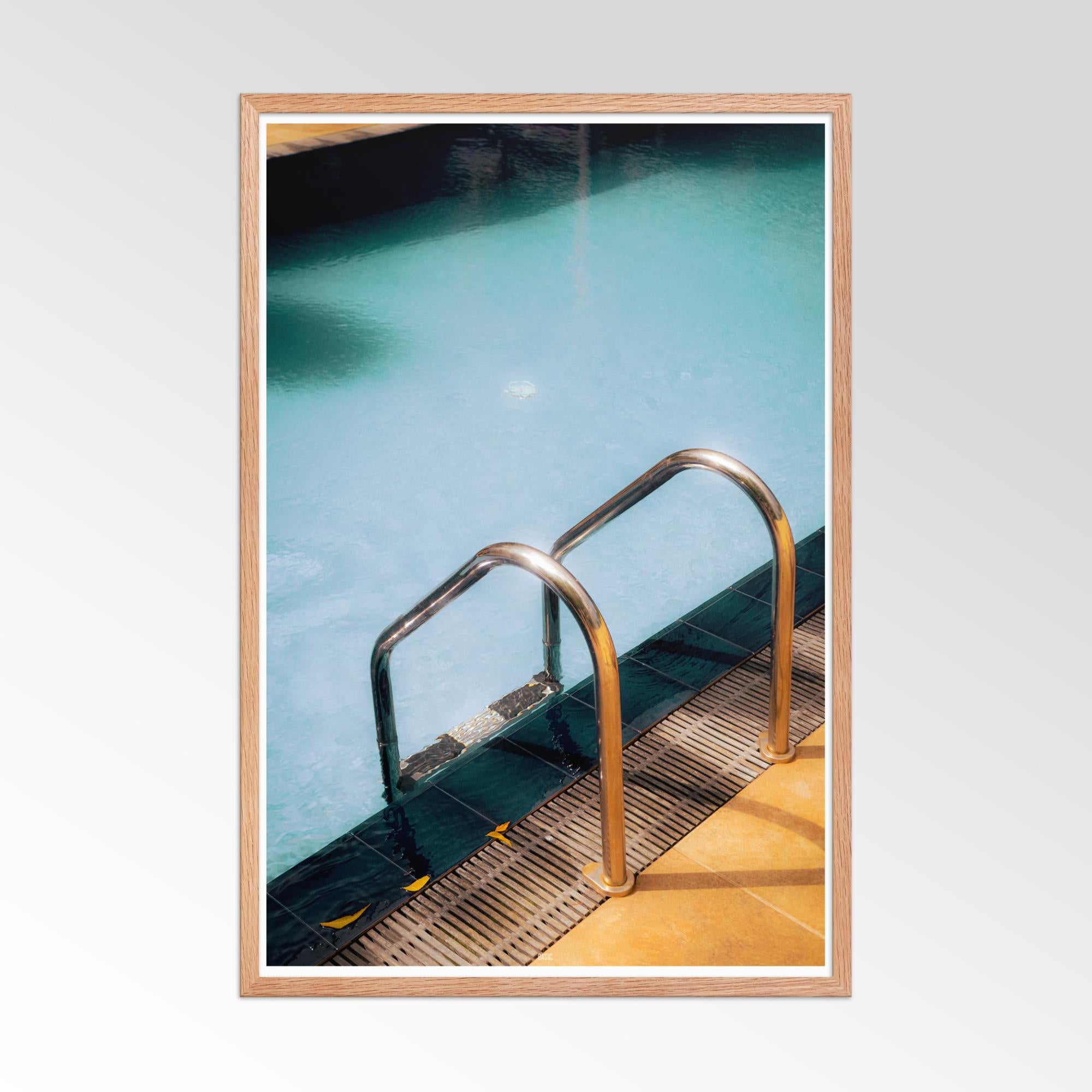 Framed photograph of a pool with a metal ladder on a light gray background