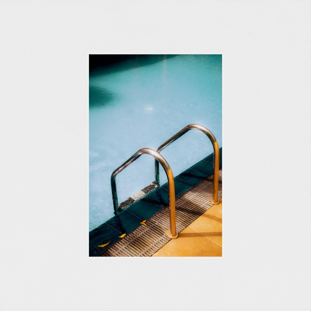 Metal ladder in a pool with a white background