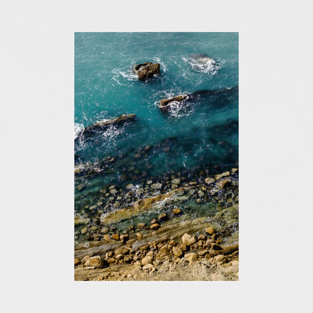 Rocks in the ocean with clear blue water