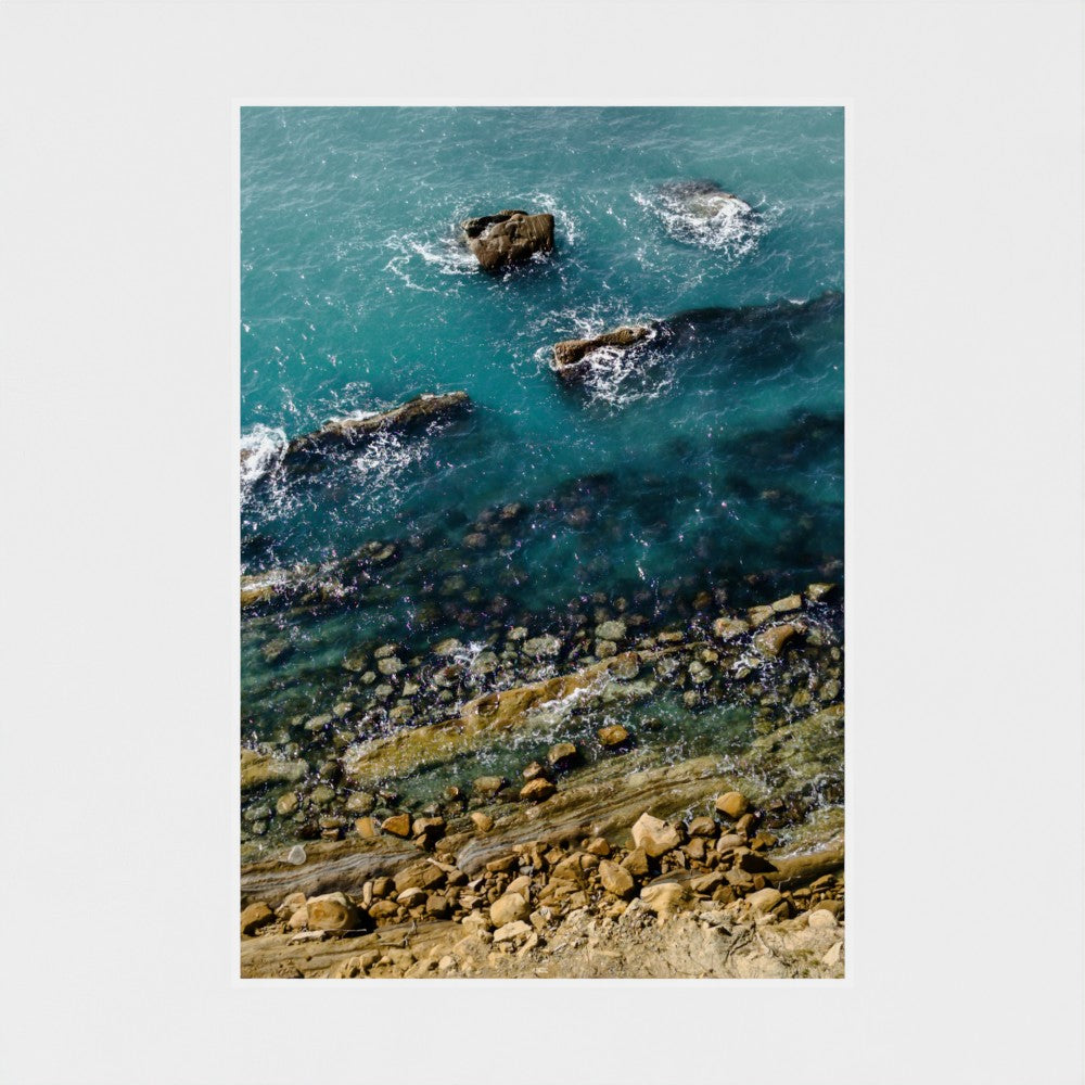 Rocks in the ocean with clear blue water