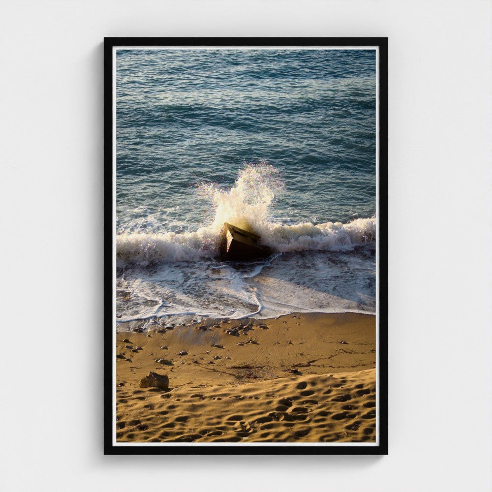 Framed photograph of waves crashing on a beach