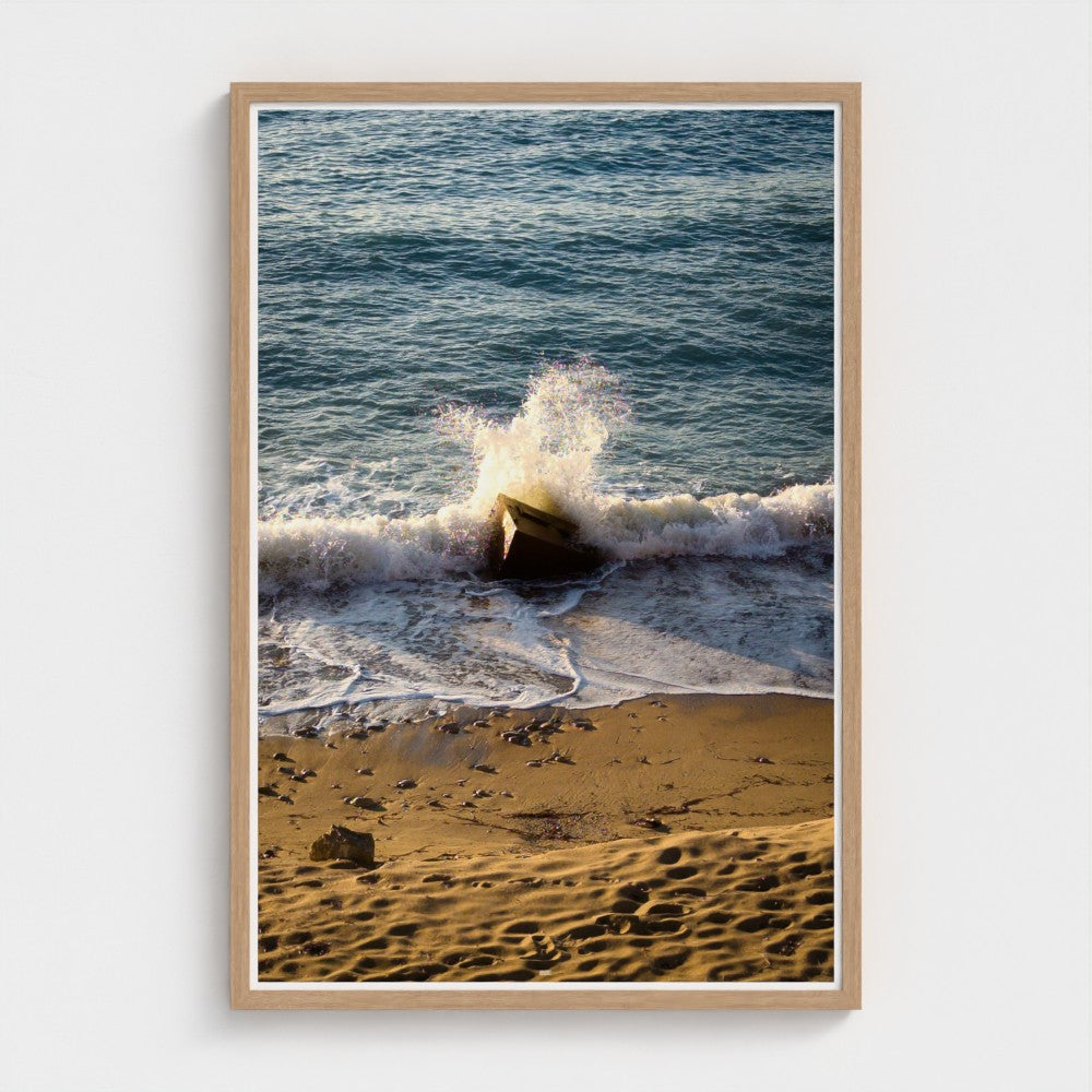 Framed photograph of waves crashing on a beach
