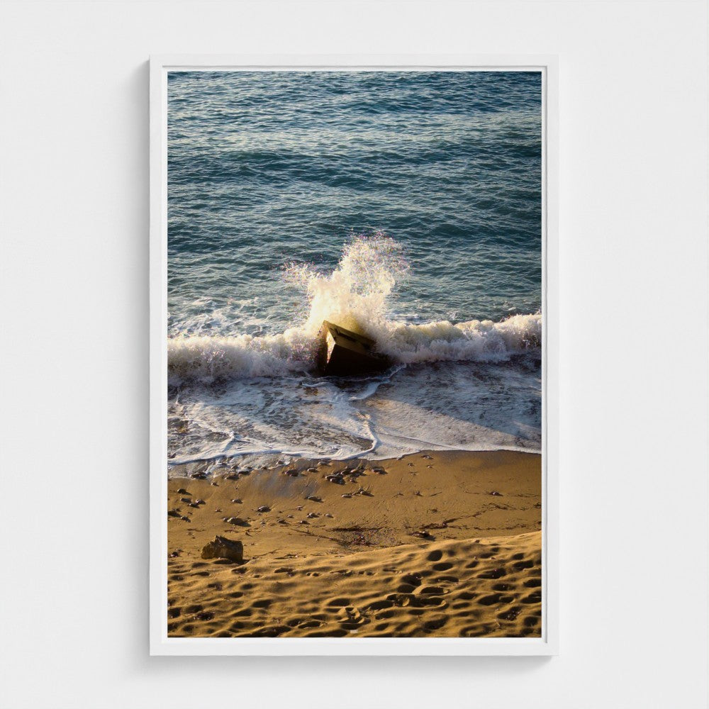 Framed photograph of waves crashing on a beach