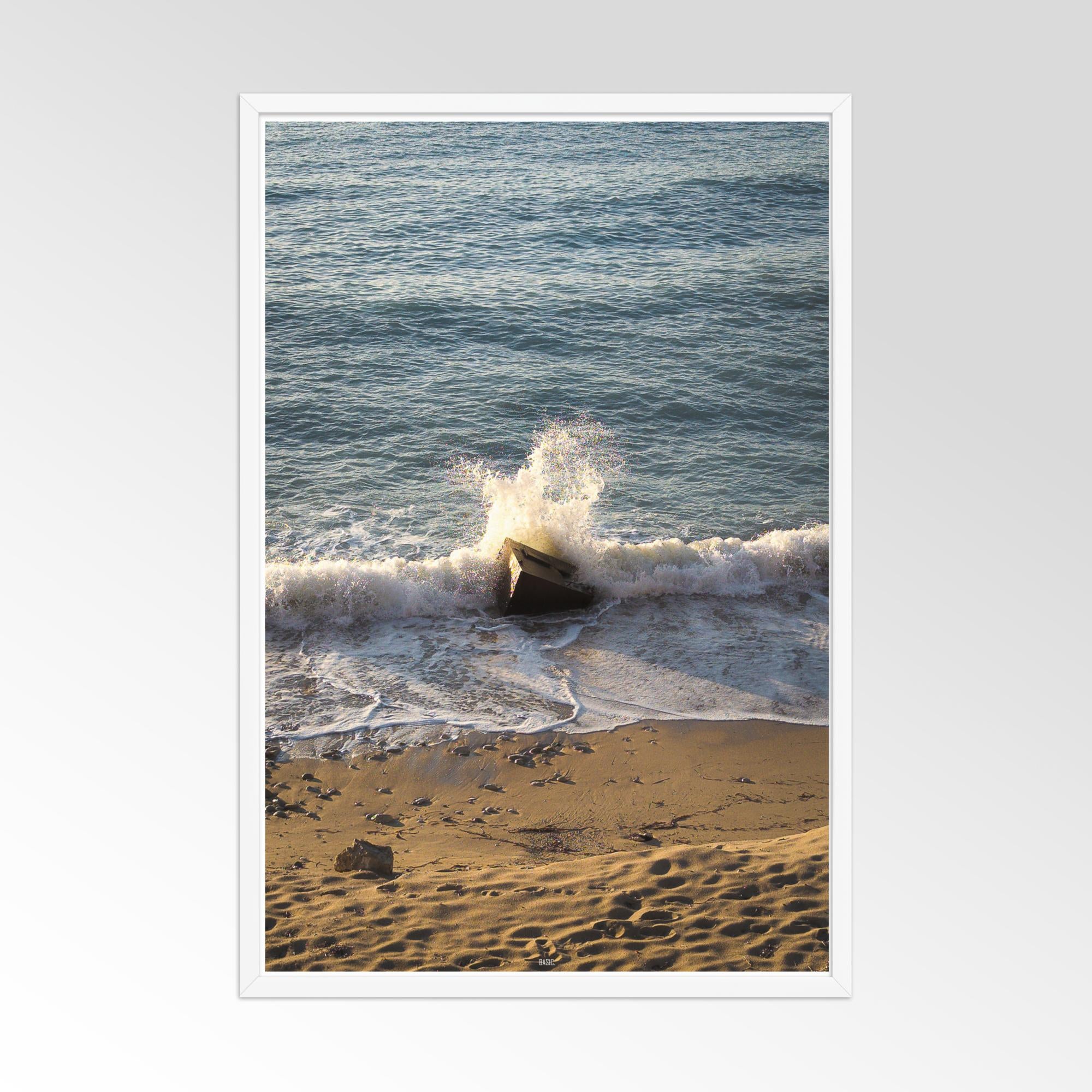 Wave crashing on a beach with a white frame