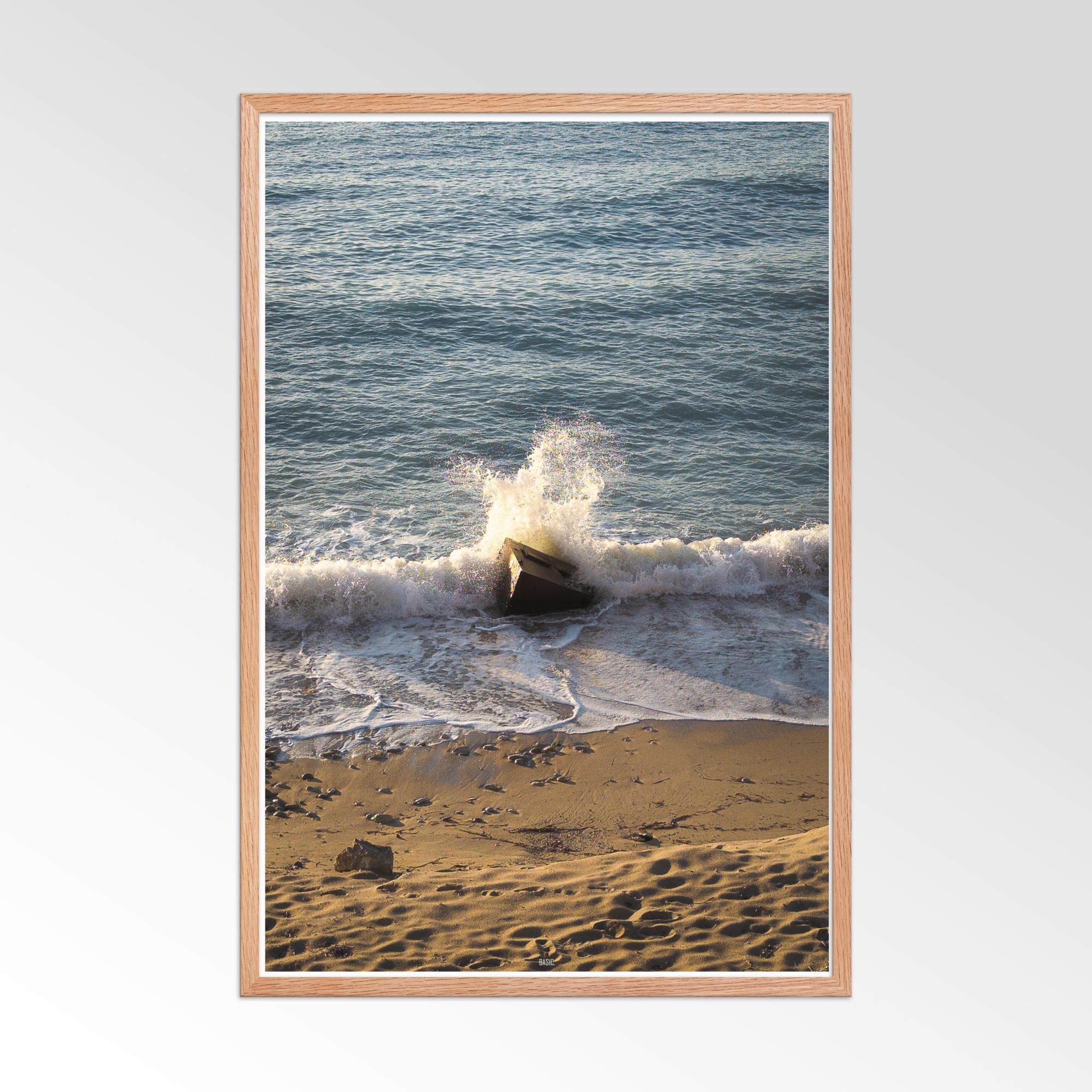 Framed photograph of waves crashing on a beach with a wooden frame.