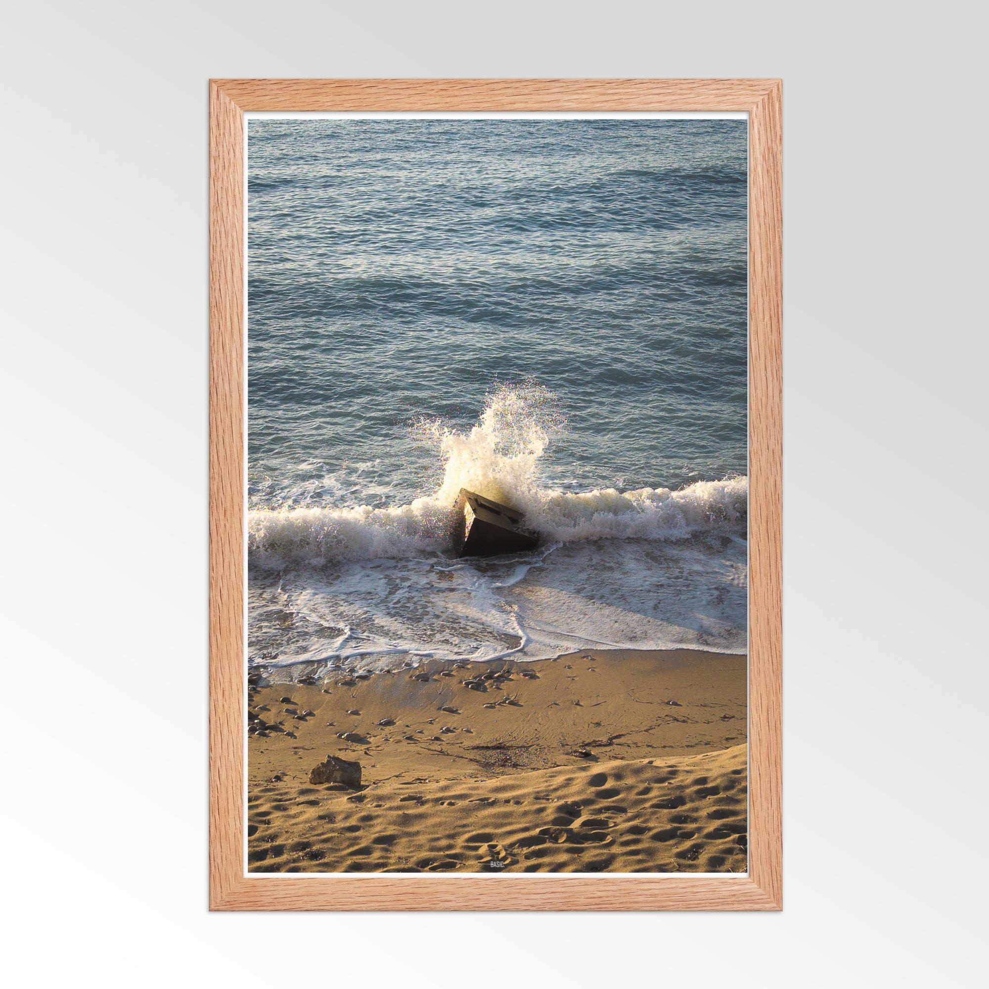 Framed photograph of a beach scene with waves crashing onto the shore.