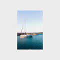 Sailboat on a body of water with a clear sky