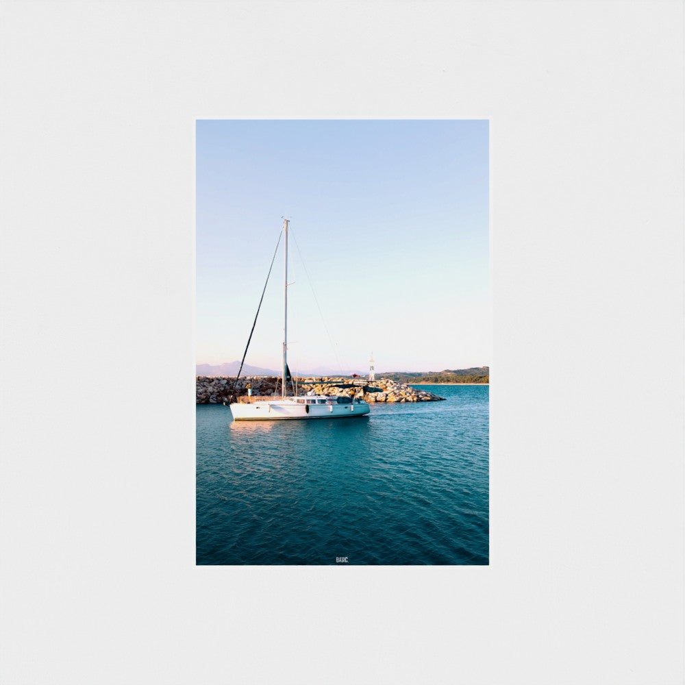 Sailboat on a body of water with a clear sky