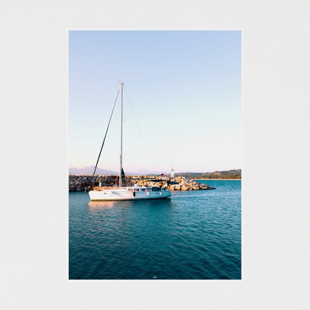 Sailing boat on a calm blue sea with a clear sky